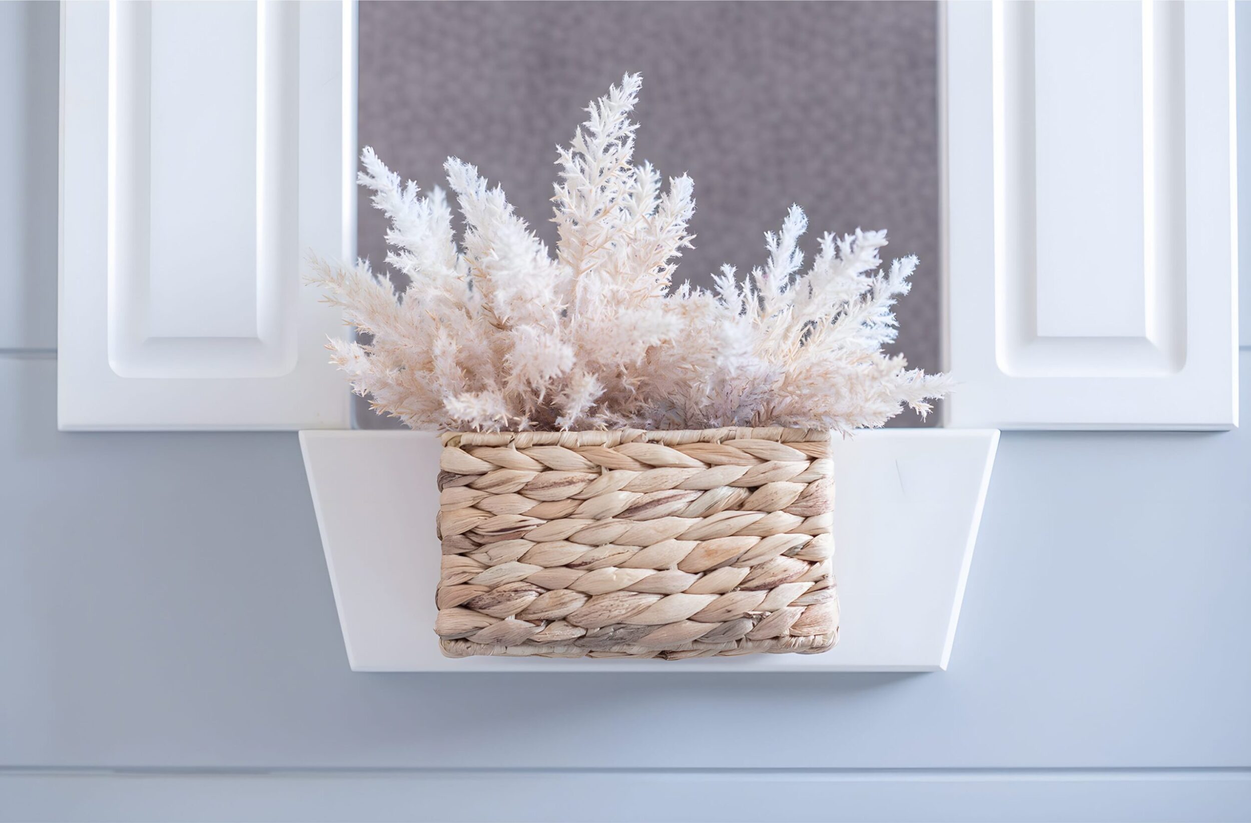 Kids’ loft bedroom with gray playhouse bed, dotted wallpaper, pink guitar, plush toys, and bright natural light