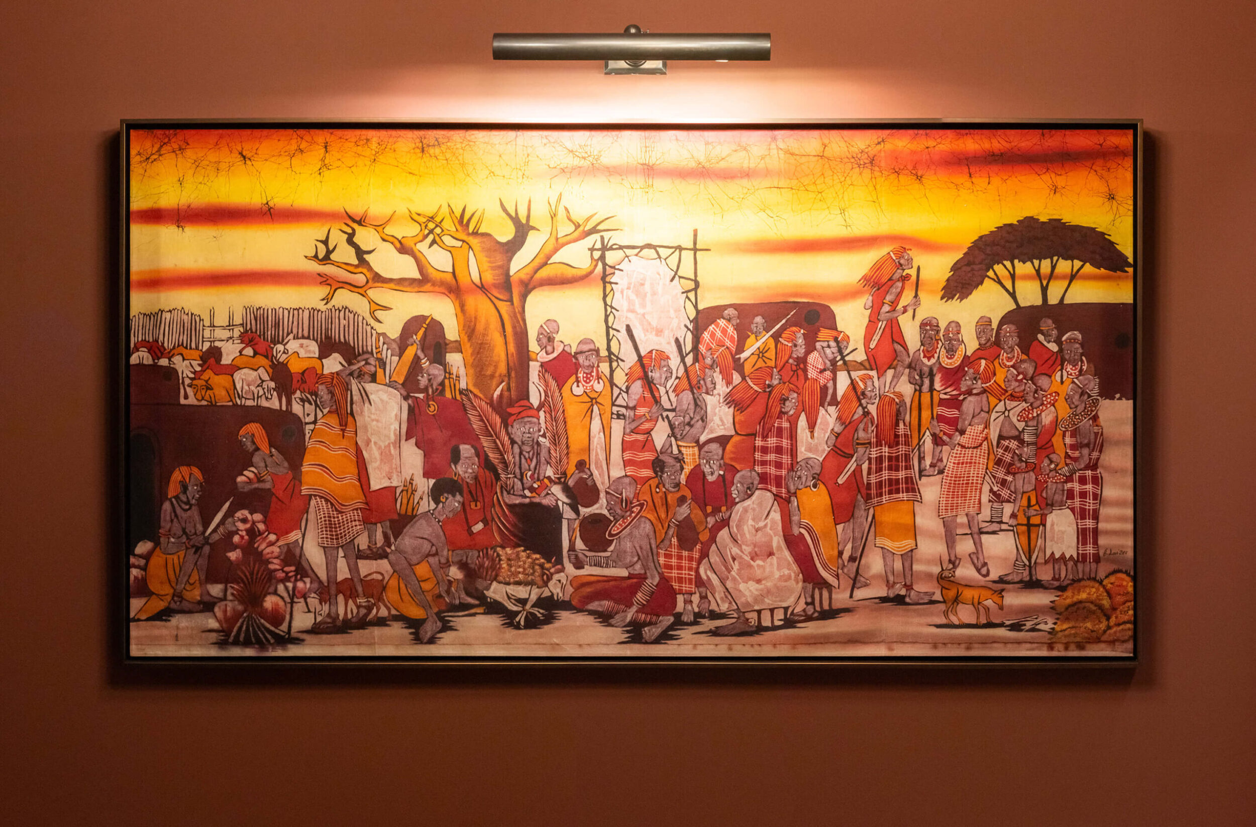 Vibrant painting of African village scene with people in colorful clothing, set under glowing orange and yellow sunset sky